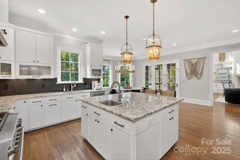 a kitchen with a sink stove top oven and cabinets