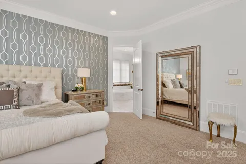 a bathroom with a double vanity sink large mirror and bathtub
