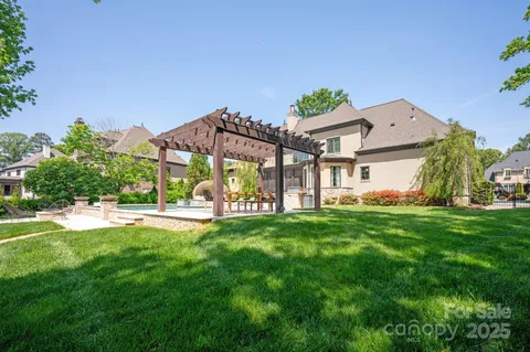 an aerial view of a house with swimming pool outdoor seating and yard