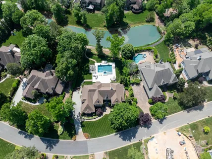 a view of a patio with table and chairs potted plants with wooden floor and fence