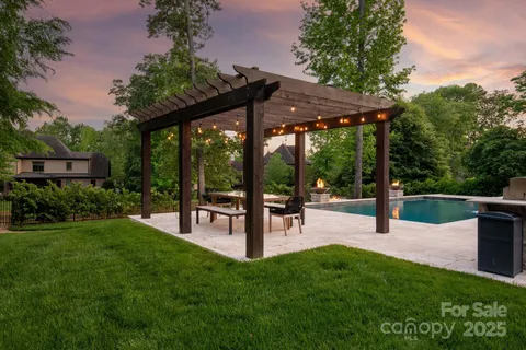 an aerial view of a house with a yard and lake view