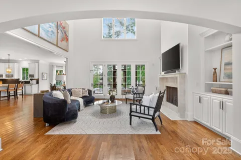 a view of a hallway with wooden floor and furniture
