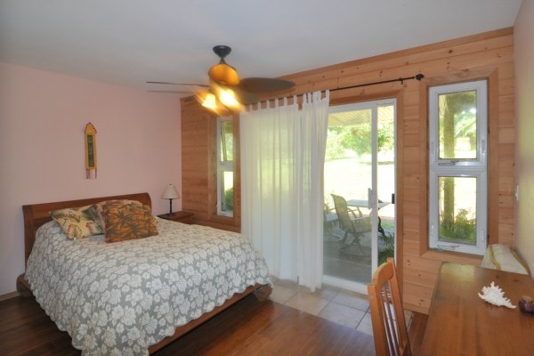 7158 Kahuna Road, Unit 1 & 2 Kapaa, HI 96746 - Photo 14 of 23 a bedroom with a large bed and a large window