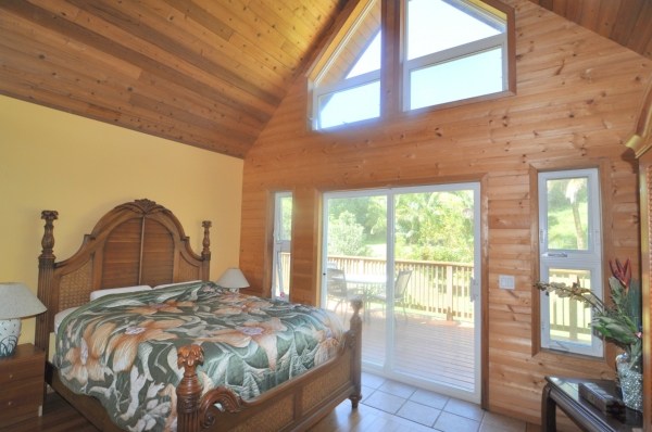 7158 Kahuna Road, Unit 1 & 2 Kapaa, HI 96746 - Photo 18 of 23 a bed sitting in a bedroom next to a window