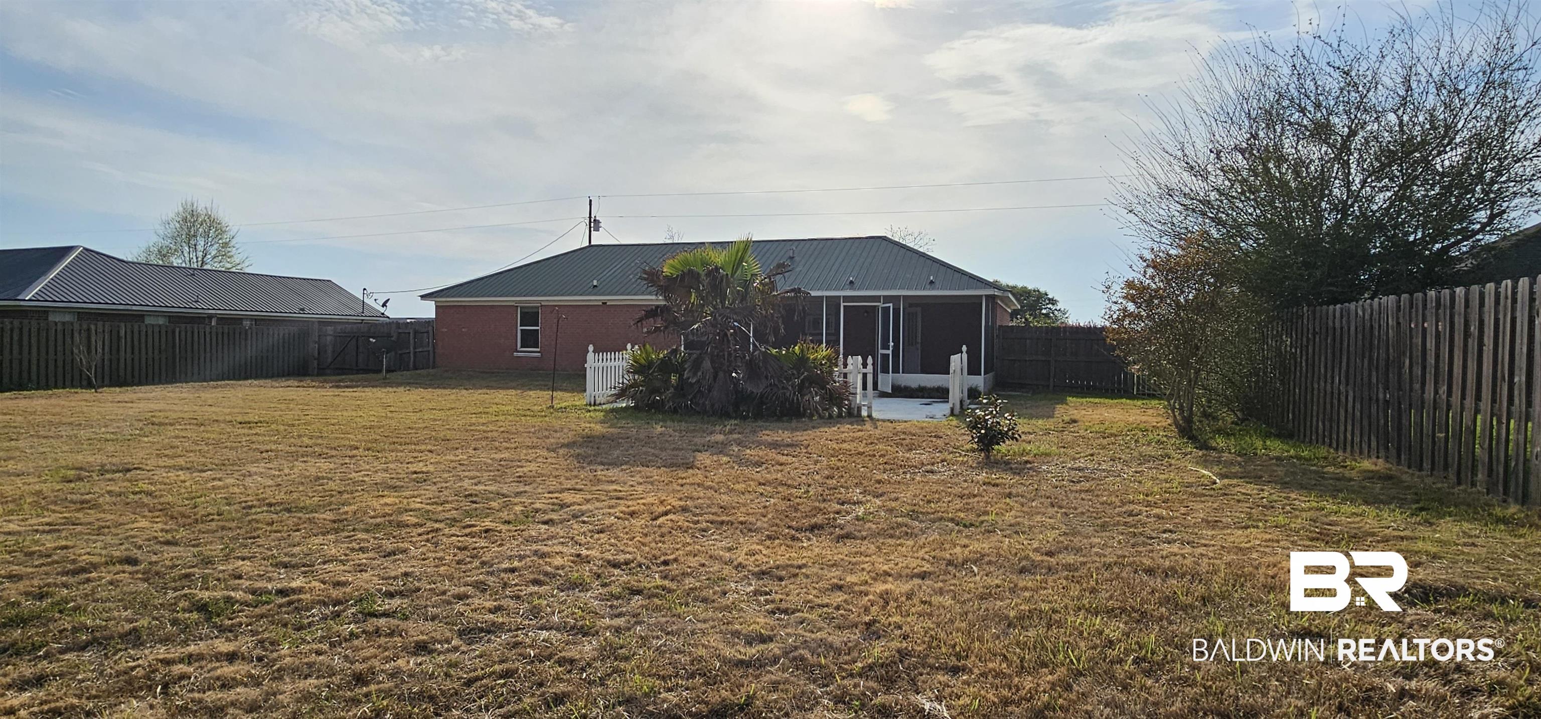 8940 Shannon's Mill Road Foley, AL 36535 - Photo 19 of 35 Back of property with a patio and a fenced backyard