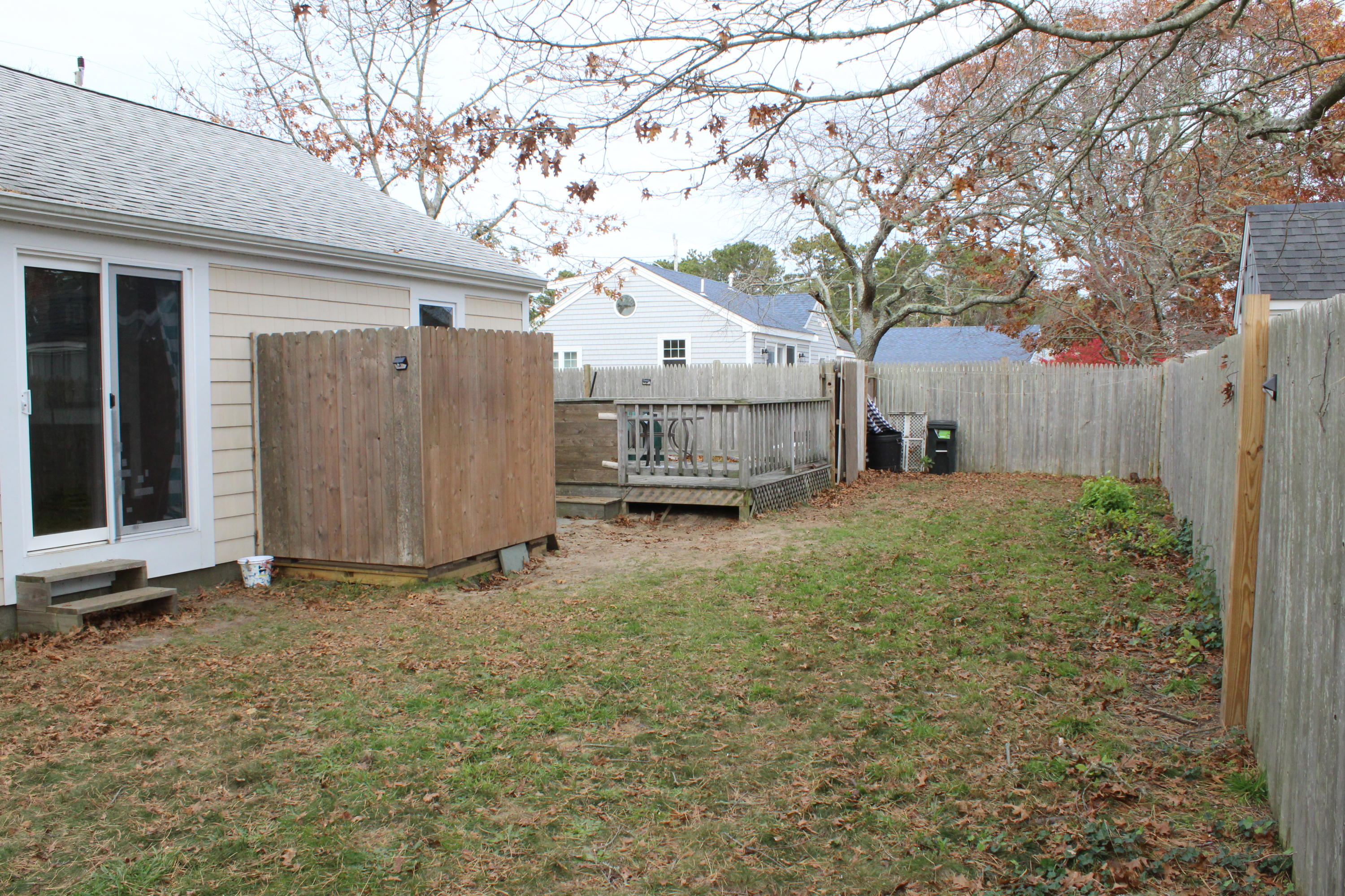 10 Uncle Rolf Road Dennis Port, MA 02639 - Photo 4 of 18 a view of a house with a large tree and wooden fence
