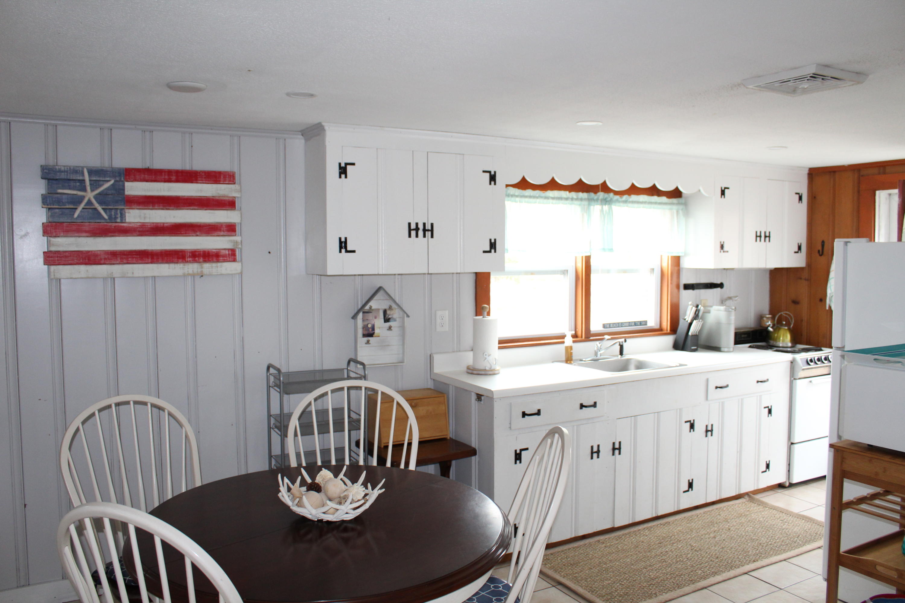 10 Uncle Rolf Road Dennis Port, MA 02639 - Photo 6 of 18 a kitchen with a appliances dining table and chairs