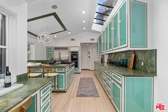 a stove top oven sitting inside of a kitchen