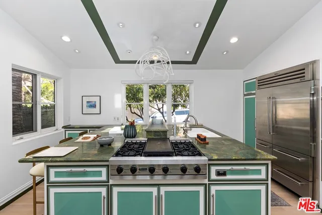 a kitchen with stainless steel appliances granite countertop a stove and a sink