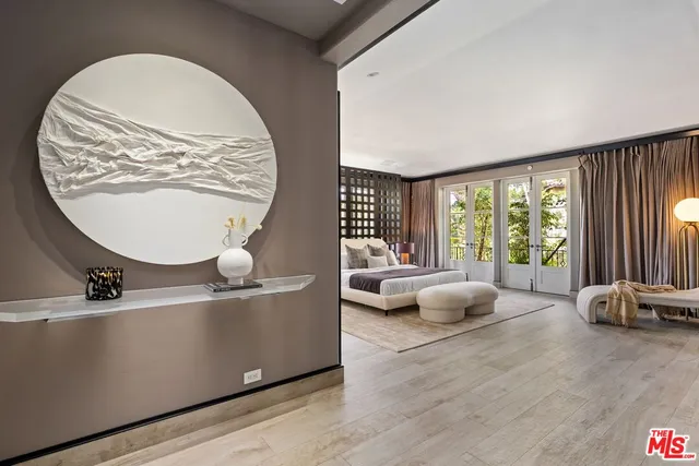 a bedroom with a large bed and a large window