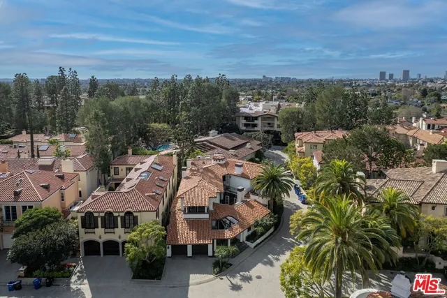 an aerial view of multiple houses with yard
