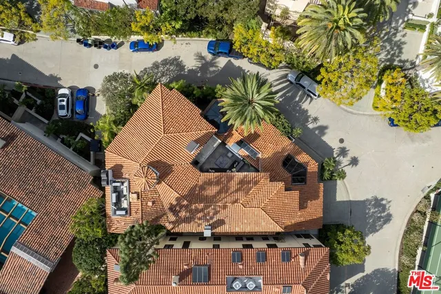 an aerial view of a house with a yard and lake view