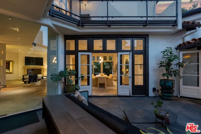 a large bedroom with a large bed and large windows