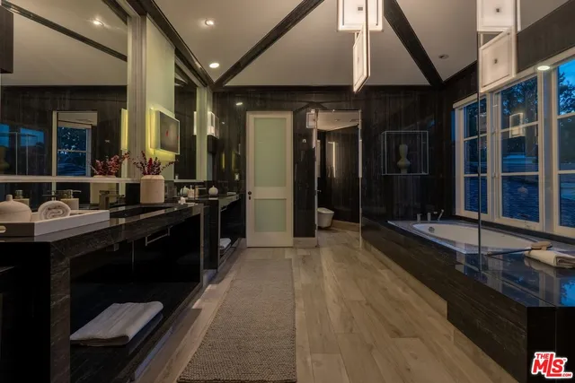 a bedroom with furniture and a large window