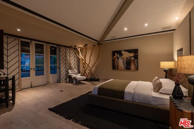 a large hall with lots of furniture and a large window