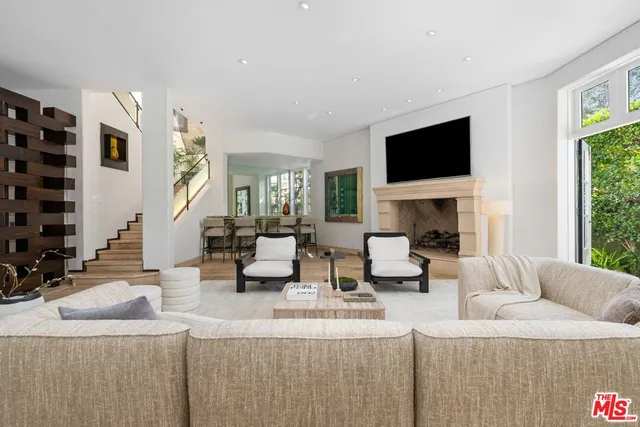 a living room with furniture and large windows