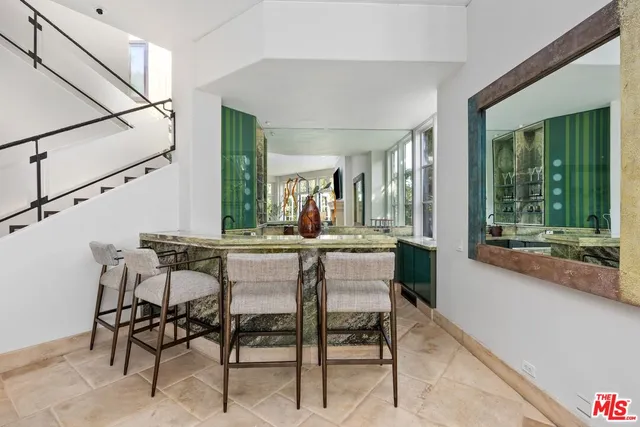 a dining room with furniture a chandelier and window