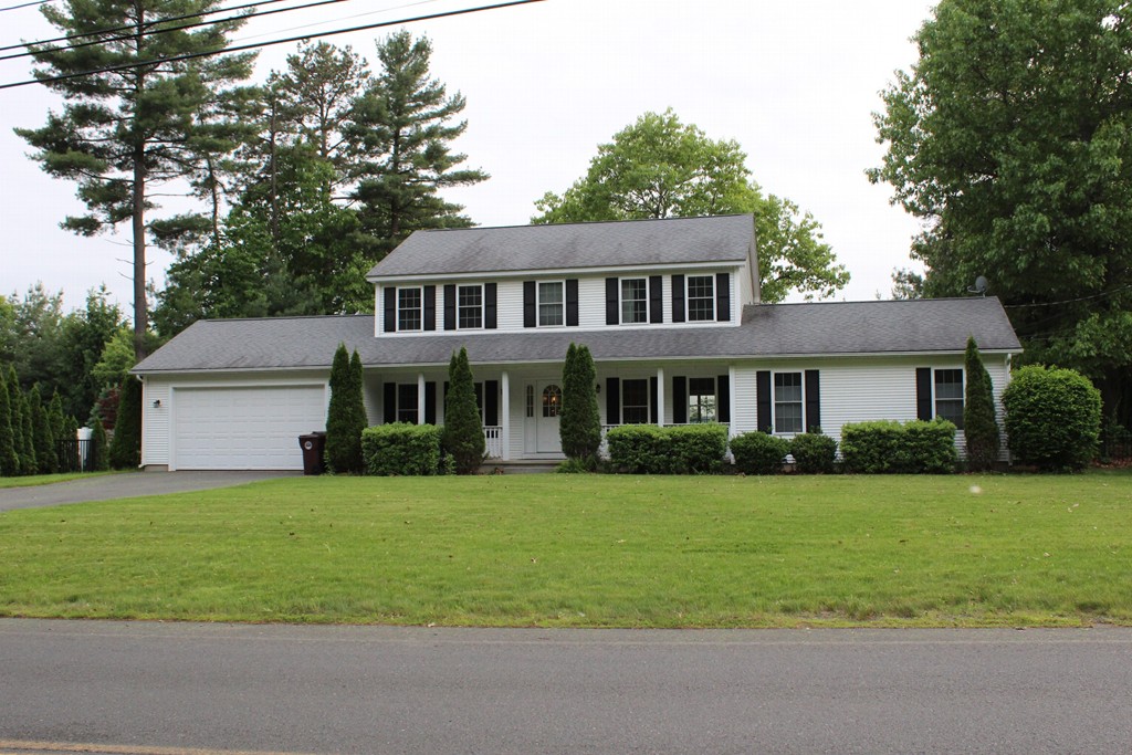 375 Springdale Road Westfield, MA 01085 - Photo 1 of 26 a front view of a house with a garden and trees