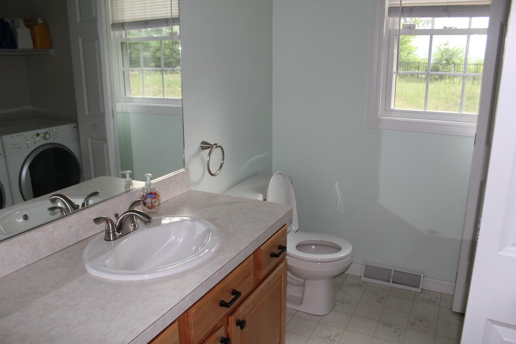 375 Springdale Road Westfield, MA 01085 - Photo 11 of 26 a bathroom with a sink a toilet and a mirror