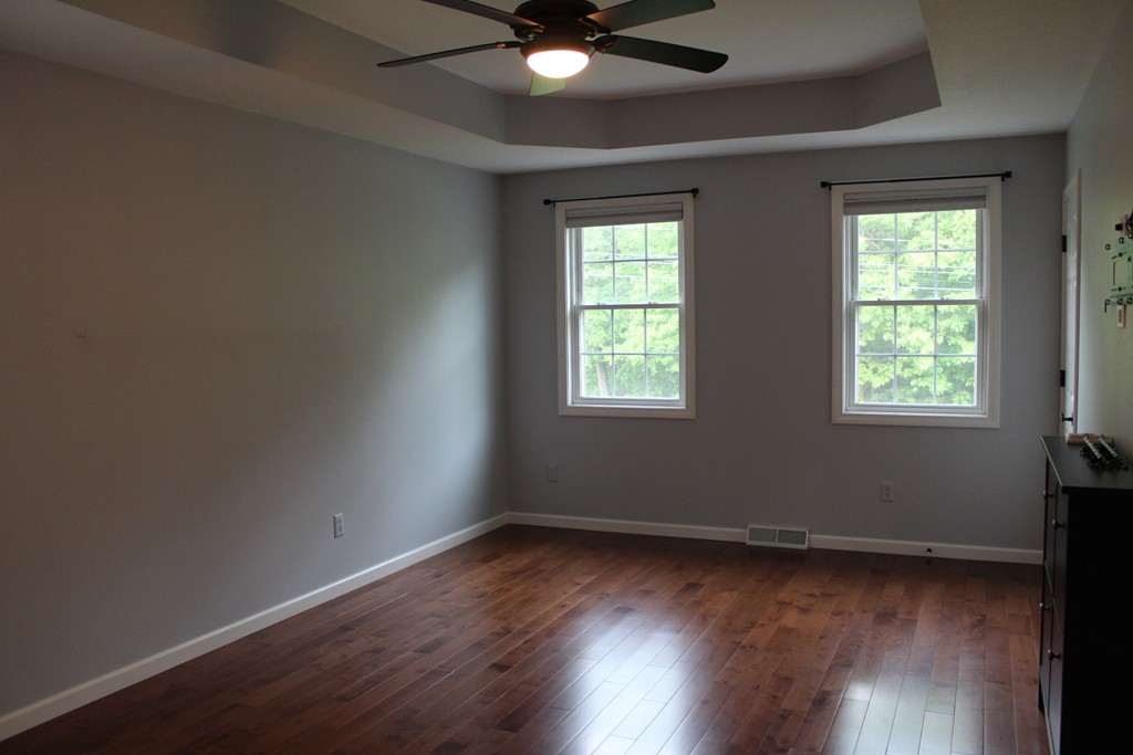 375 Springdale Road Westfield, MA 01085 - Photo 16 of 26 an empty room with wooden floor and windows