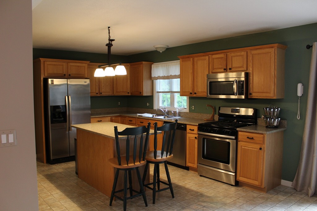375 Springdale Road Westfield, MA 01085 - Photo 2 of 26 a kitchen with granite countertop a stove top oven a sink and a microwave