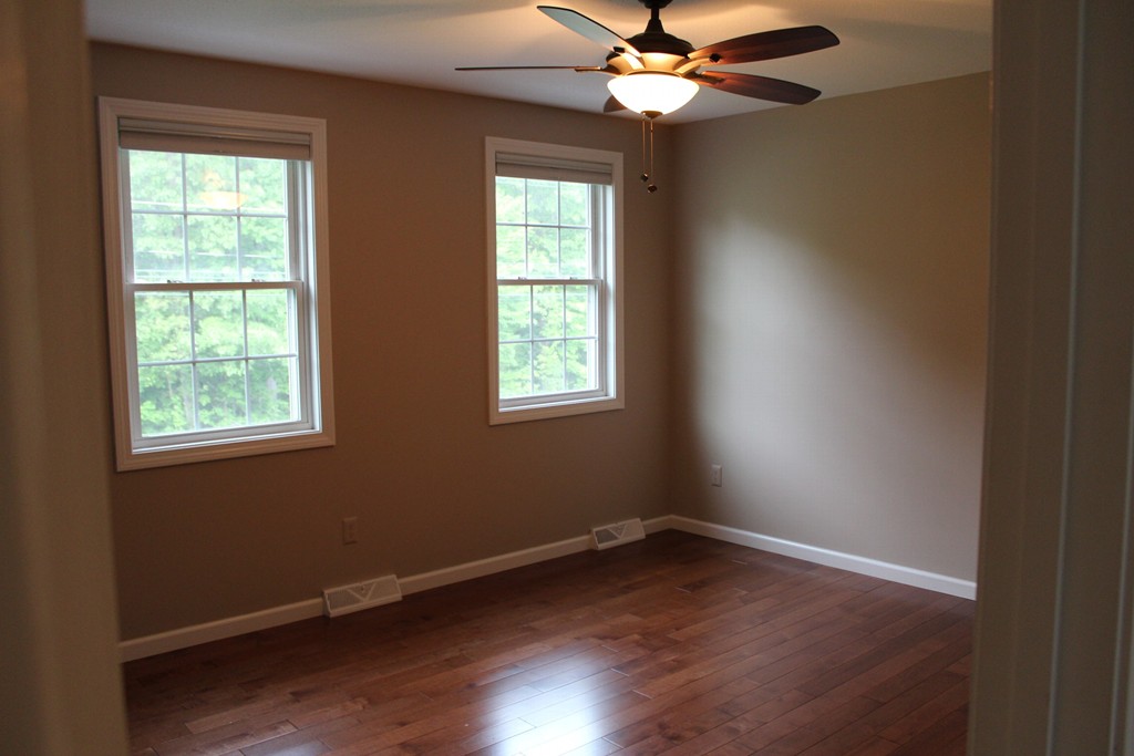 375 Springdale Road Westfield, MA 01085 - Photo 23 of 26 an empty room with wooden floor windows and fan