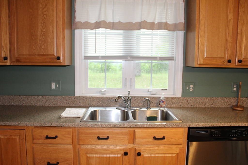 375 Springdale Road Westfield, MA 01085 - Photo 4 of 26 a kitchen with kitchen island a sink a window and cabinets