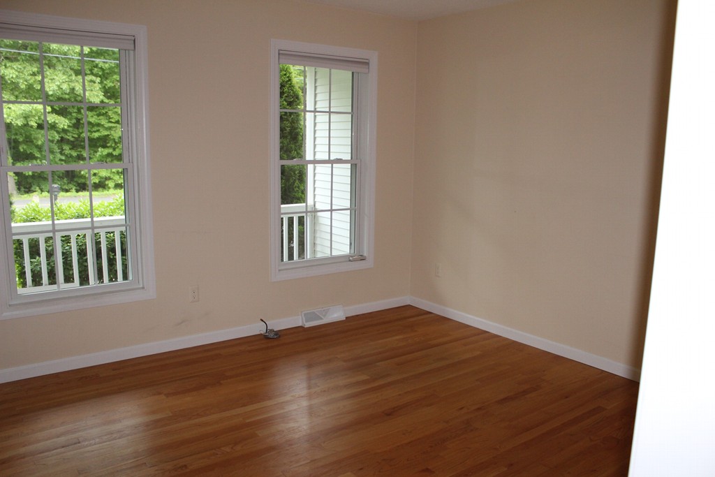375 Springdale Road Westfield, MA 01085 - Photo 10 of 26 an empty room with wooden floor and windows