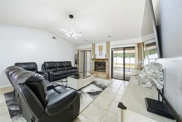 a living room with furniture a lamp and a window