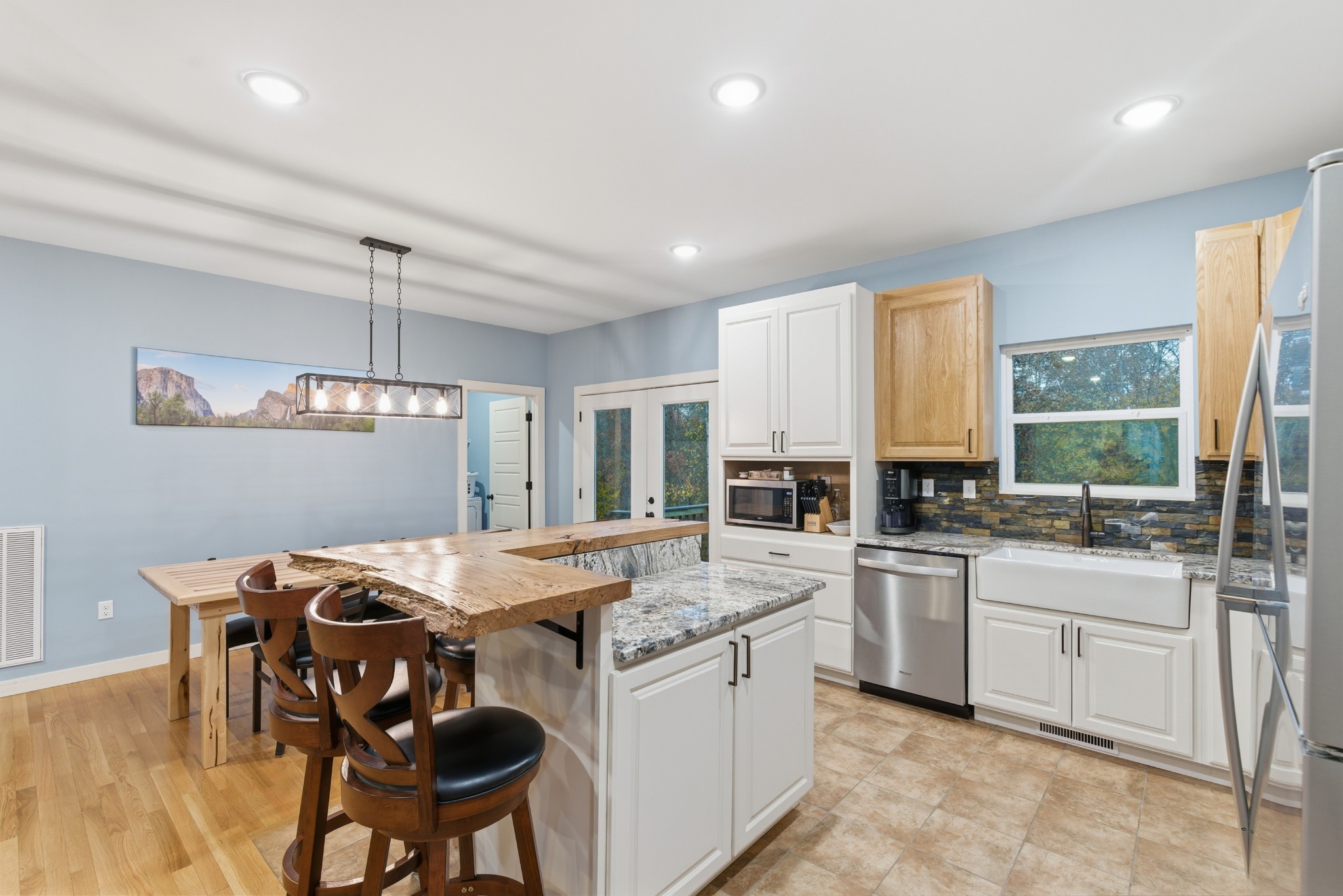 4310 Surji Circle Centerville, TN 37033 - Photo 11 of 27 a kitchen with stainless steel appliances granite countertop a stove a sink a microwave a dining table and chairs