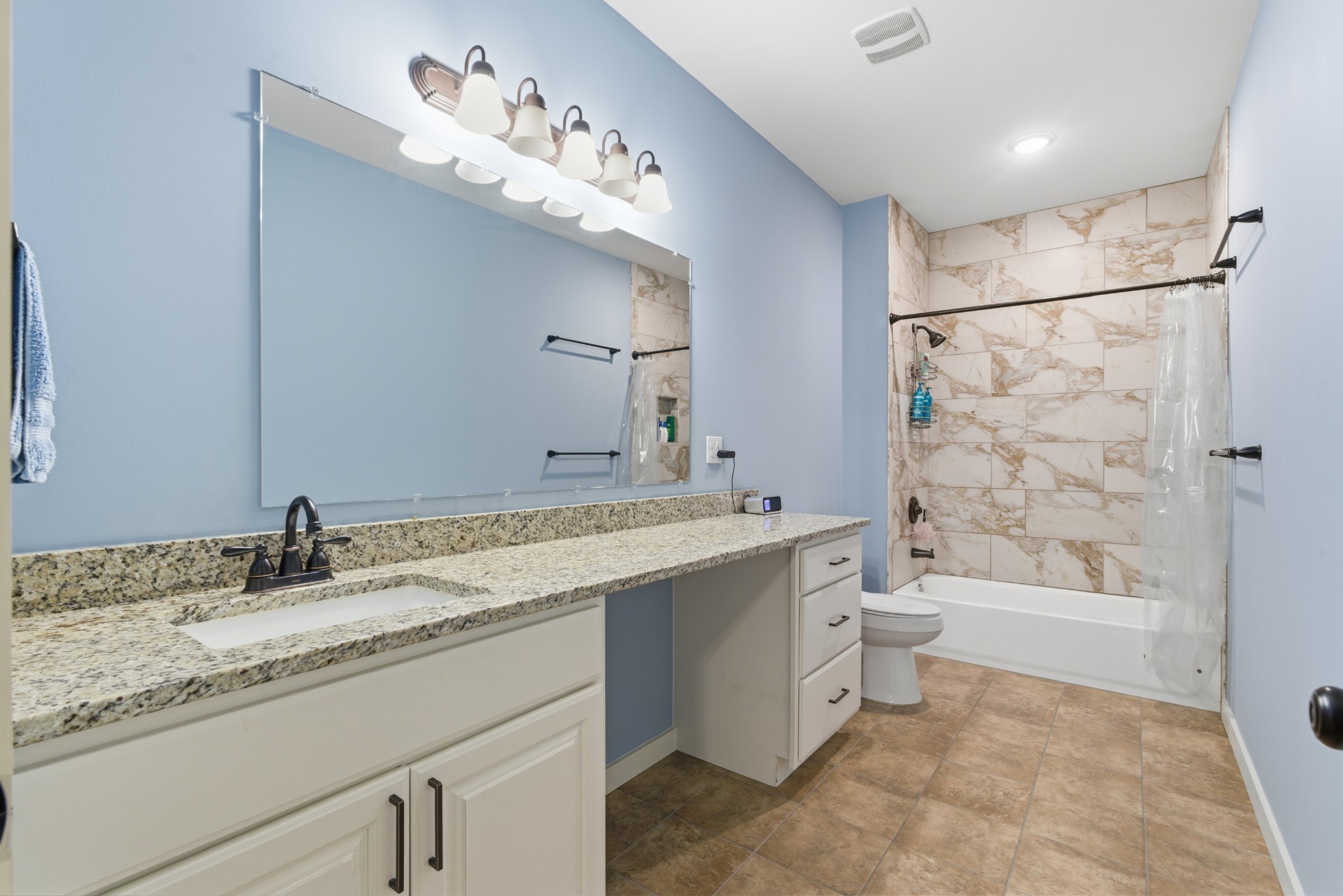 4310 Surji Circle Centerville, TN 37033 - Photo 17 of 27 a bathroom with a granite countertop sink mirror toilet and bathtub