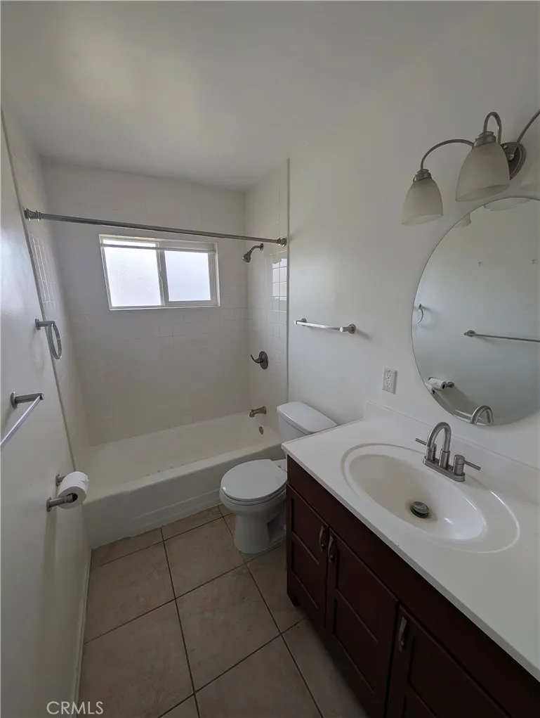 8641 Garfield Street, Unit 1 Riverside, CA 92504 - Photo 10 of 19 a bathroom with a sink and mirror with bathtub