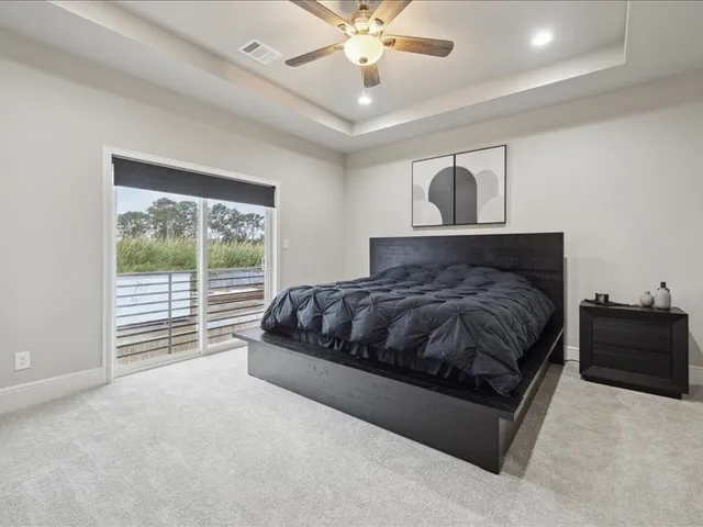 a bedroom with a large bed and a window