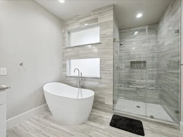 a bathroom with a bathtub and shower