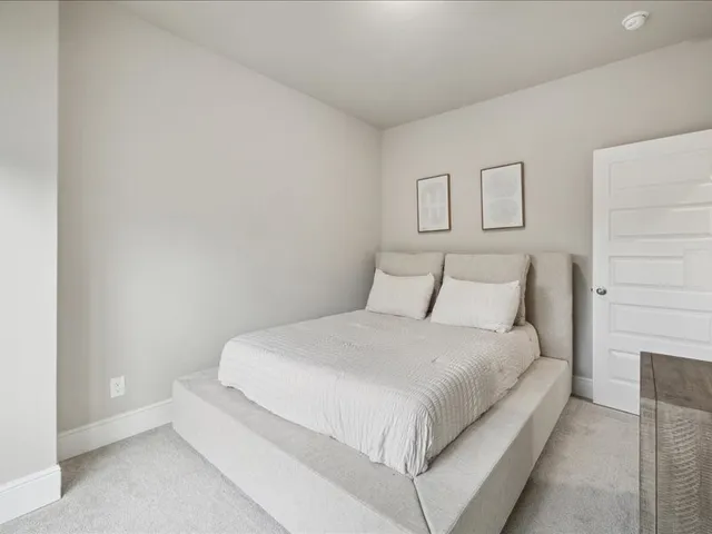 a bedroom with a bed and a night stand