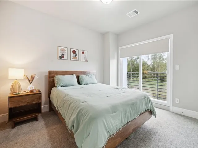 a bedroom with a bed and a window