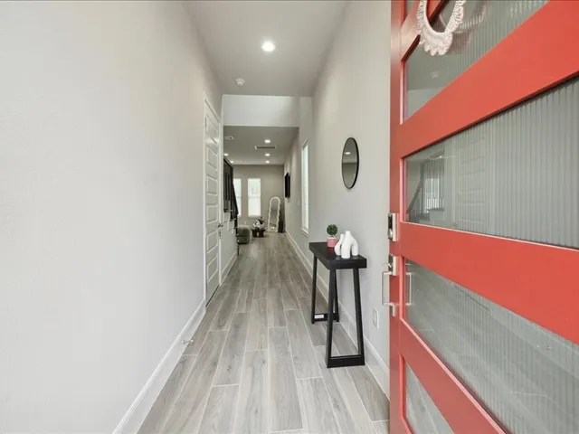 a hallway with a large mirror and a window
