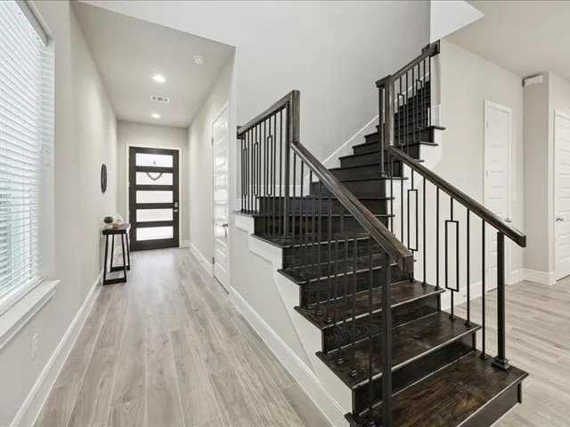 a view of entryway and hall with wooden floor