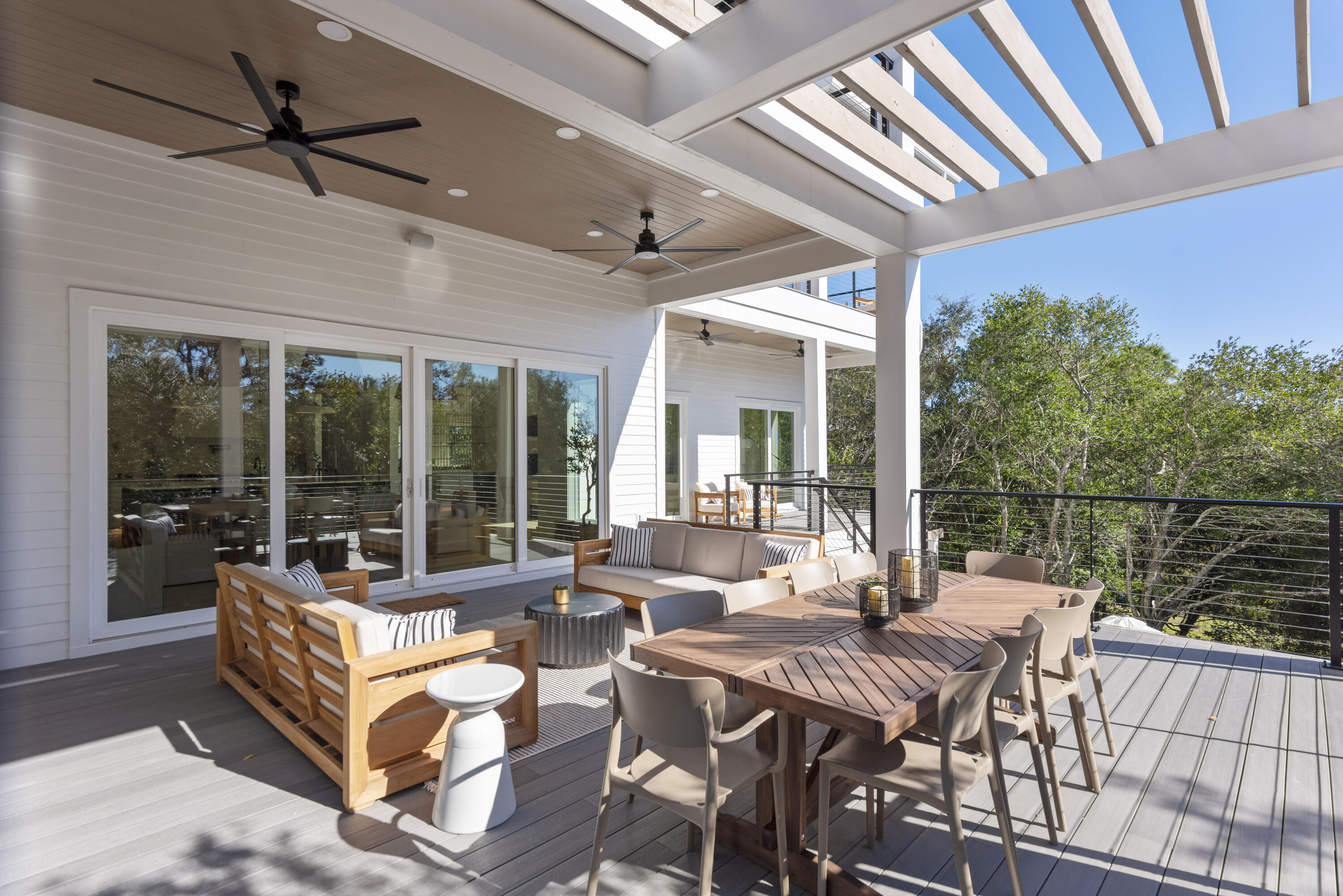 185 Dune Drive Santa Rosa Beach, FL 32459 - Photo 13 of 53 a view of a patio with couches table and chairs