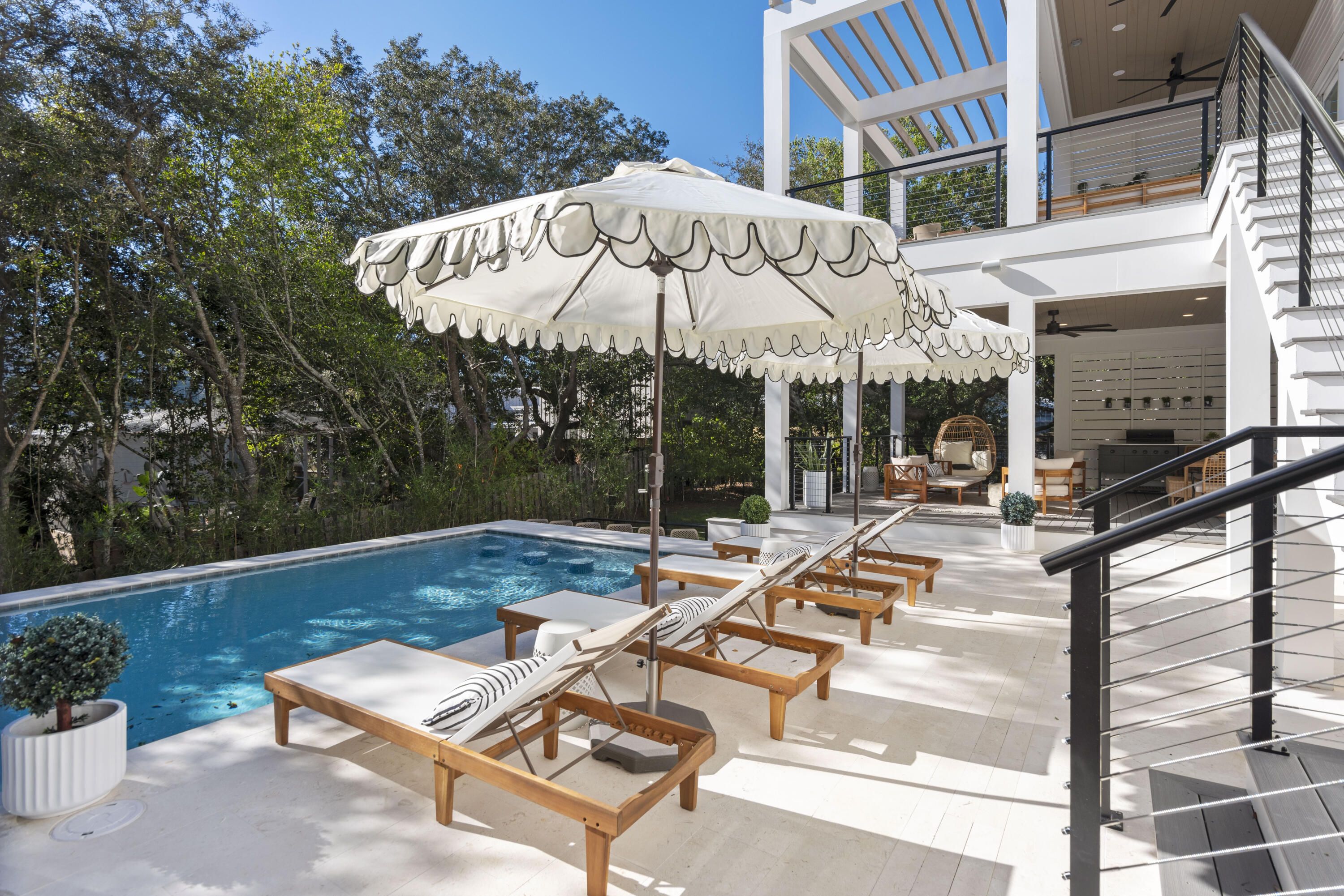 185 Dune Drive Santa Rosa Beach, FL 32459 - Photo 23 of 53 a view of a patio with a table and chairs under an umbrella