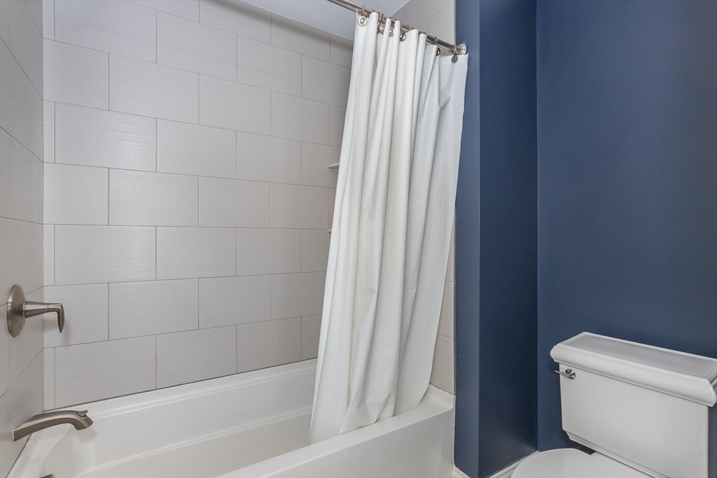 25 Brookview Road, Unit 25 Franklin, MA 02038 - Photo 19 of 28 a bath room with a toilet and a bath tub