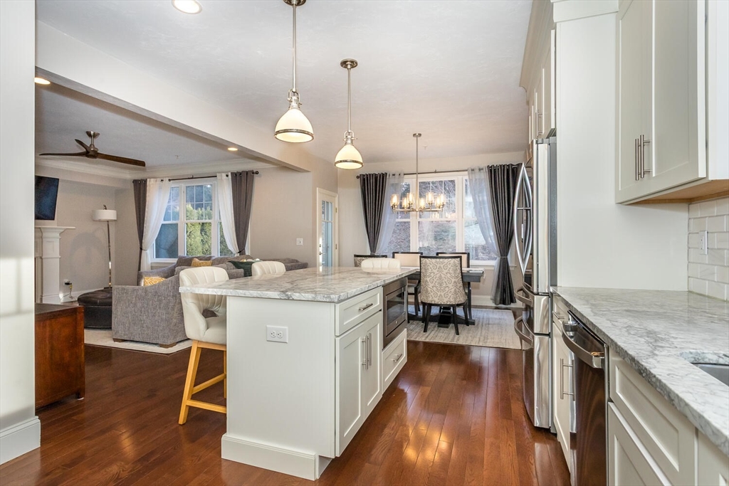 25 Brookview Road, Unit 25 Franklin, MA 02038 - Photo 9 of 28 a kitchen with stainless steel appliances granite countertop a lot of counter space and wooden floors