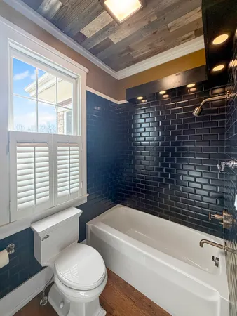 a bathroom with a toilet a sink and bathtub