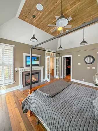 a bedroom with a bed and a chandelier
