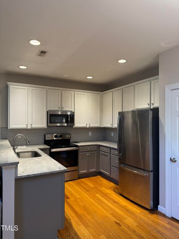 a kitchen with a refrigerator sink and microwave