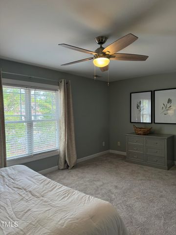 a view of empty room with window and ceiling fan