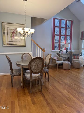 a living room with furniture two window and a wooden floor