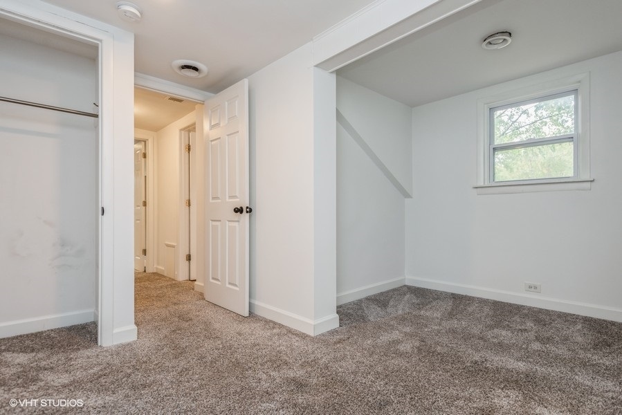 8640 East Prairie Road Skokie, IL 60076 - Photo 24 of 39 a view of an empty room with windows and closet