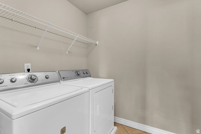 1136 West Spencer Road, Unit Y203 Pleasant Grove, UT 84062 - Photo 21 of 26 Laundry area with washing machine and clothes dryer and light tile patterned floors