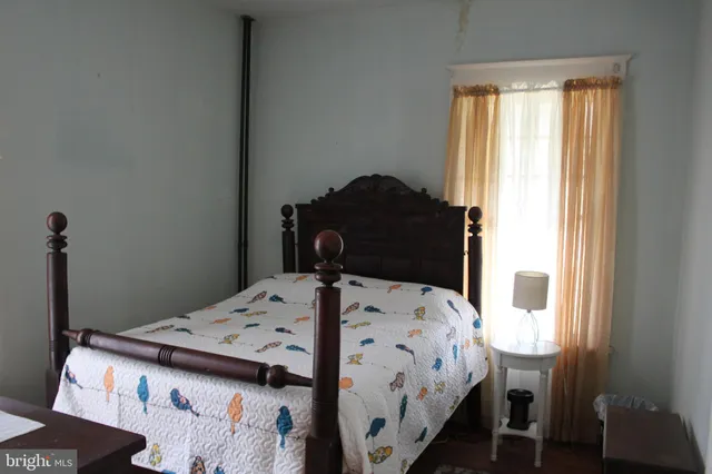 a bedroom with a bed and a table